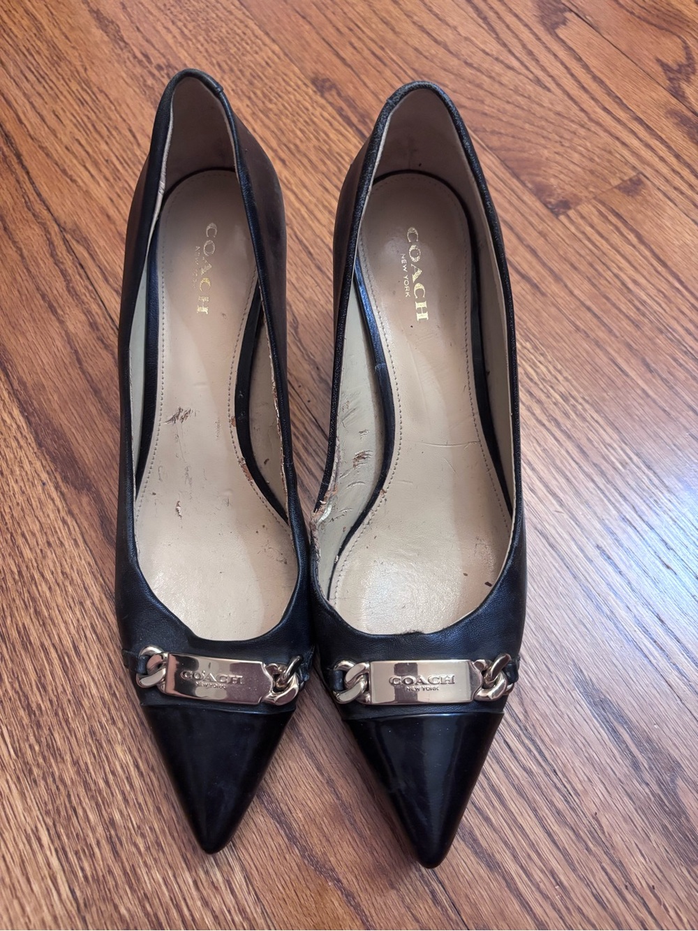 Coach Black Pointed Toe Pumps with Gold Chain Plaque